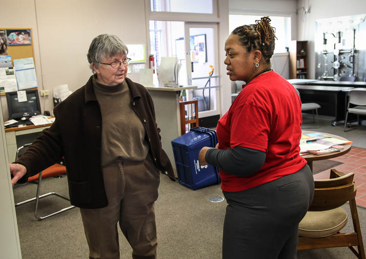 Carma Lewis (right) speaks with Jane Richardson, a volunteer at the Neighborhood Engagement Hub on Martin Luther King Avenue in Flint.