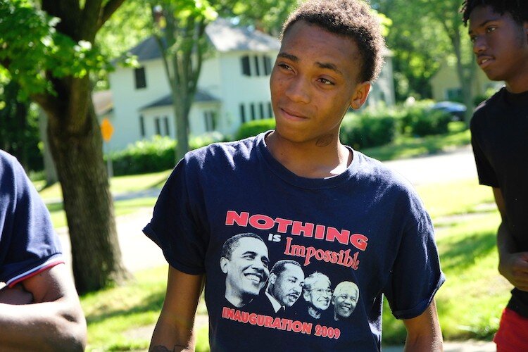 Cedreon Chapman, 16, listens to supervisor Nikita Johnson on brush removal at the Urban Renaissance Agricultural House.