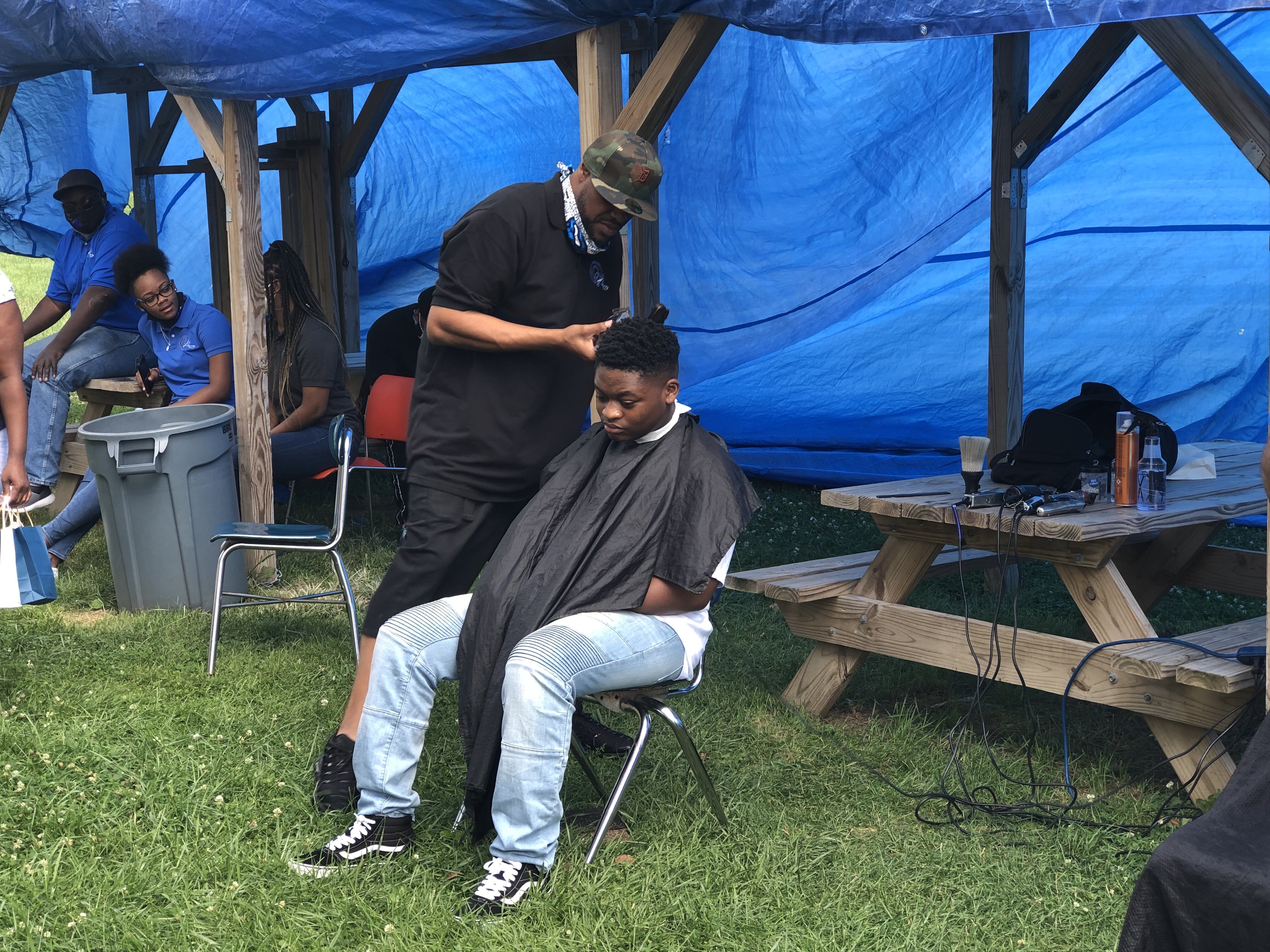 Roy Nichols, founder of Charity C.U.T.S. finished up a haircut at Berston Fieldhouse.