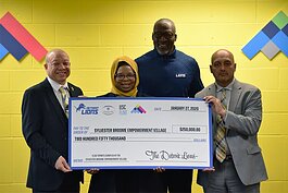  (Left to right) Mayor Sheldon Neeley, Executive Director of the SBVE Maryum Rasool, former Detroit Lions offensive tackle Lomas Brown, and SBVE Chairman Dr. Jawad Shah hold the $250,000 check dedicated to creating a new athletic space in Flint. 