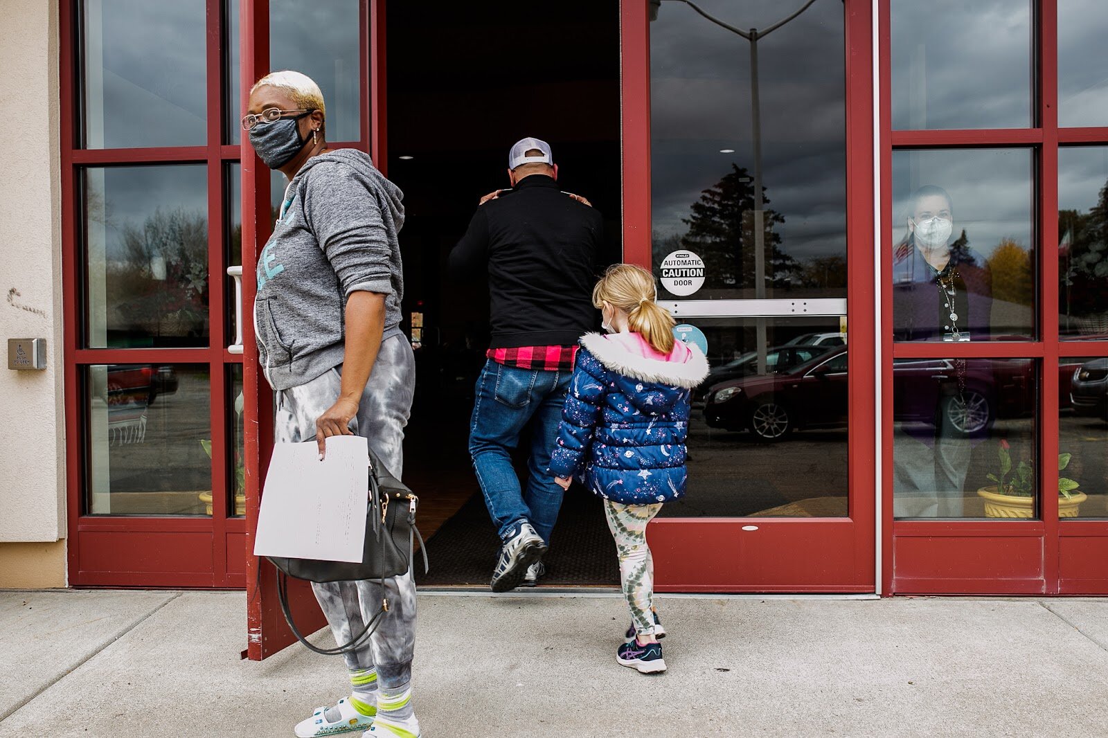 Marin Derwin and her father Tom Derwin enter Our Lady of Guadalupe's hosted GCHD vaccine clinic.