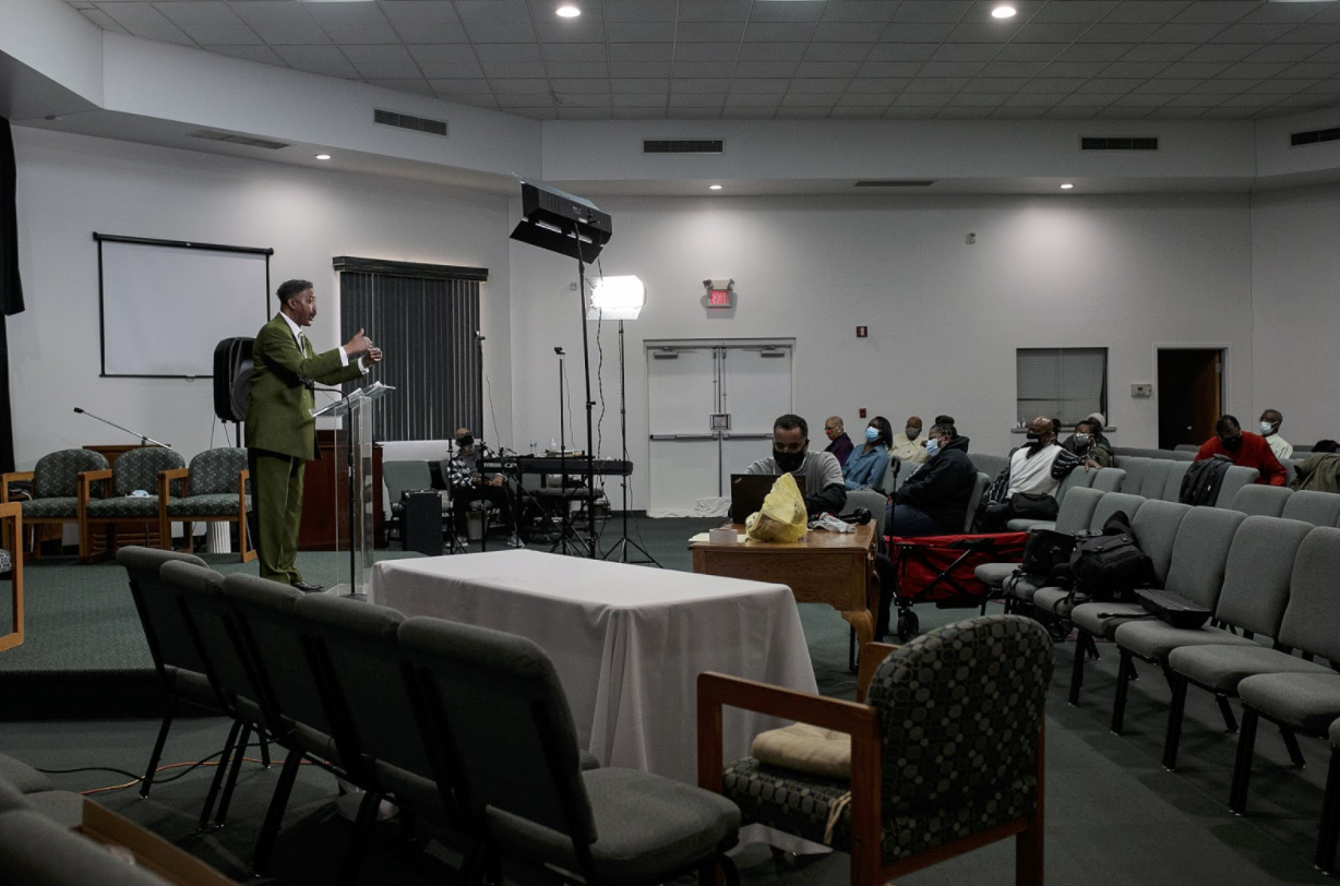 Elders, deacons, and praise team members fill the small New Jerusalem auditorium on a Sunday morning to prepare for the live broadcast of New Jerusalem's church service.