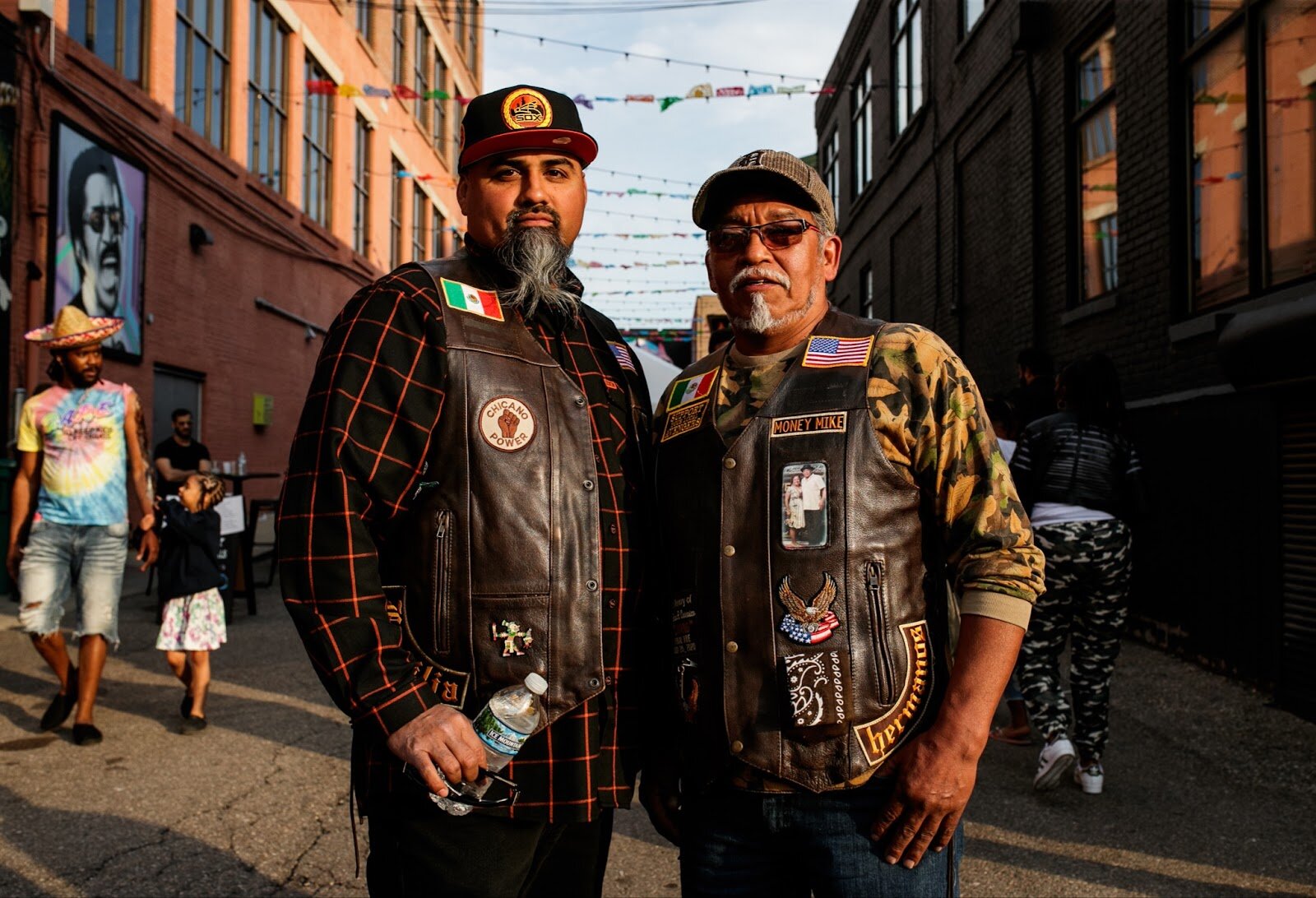 (Left to right) Tony and Cruz Asencio pose for a portrait during the Latinx Technology & Community Center’s Cinco de Mayo celebration on Friday, May 5, 2023, in Buckham Alley in downtown Flint.