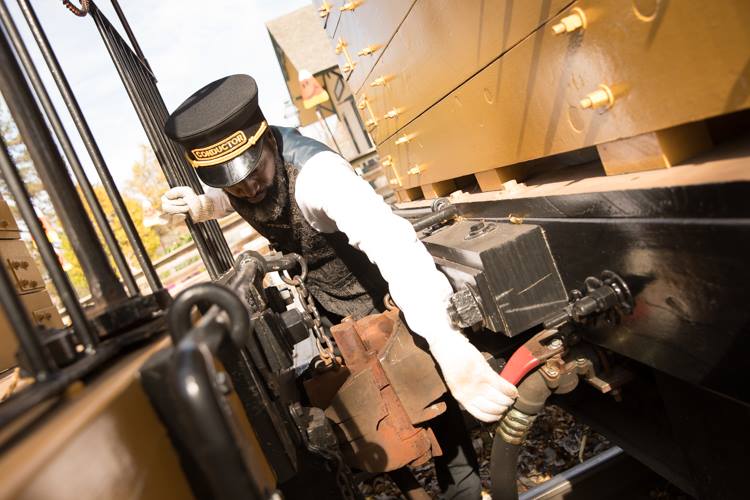 Larry Coleman says safety is a top priority for conductors of the Huckleberry Railroad. He checks every coupling, every brake, and every seat in every car before visitors board the train.