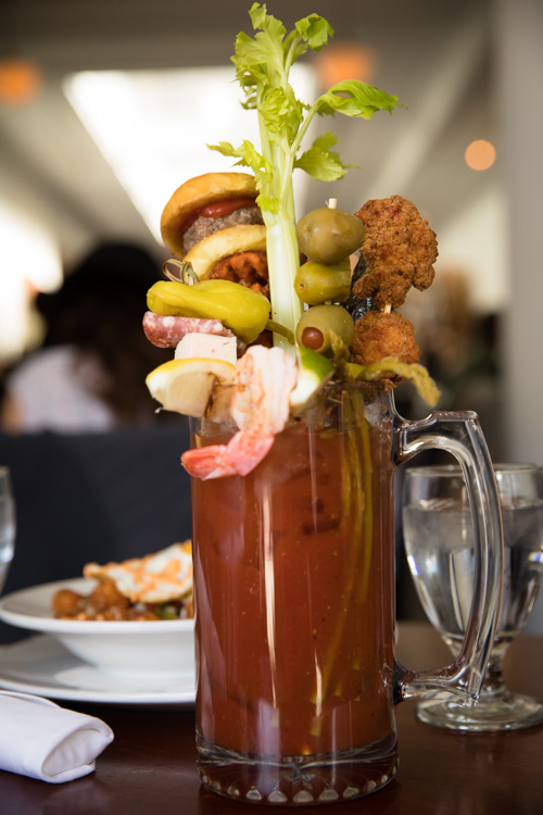 Served in a 25-ounce glass, the Loaded Bloody Mary at Cork is a tall drink. 