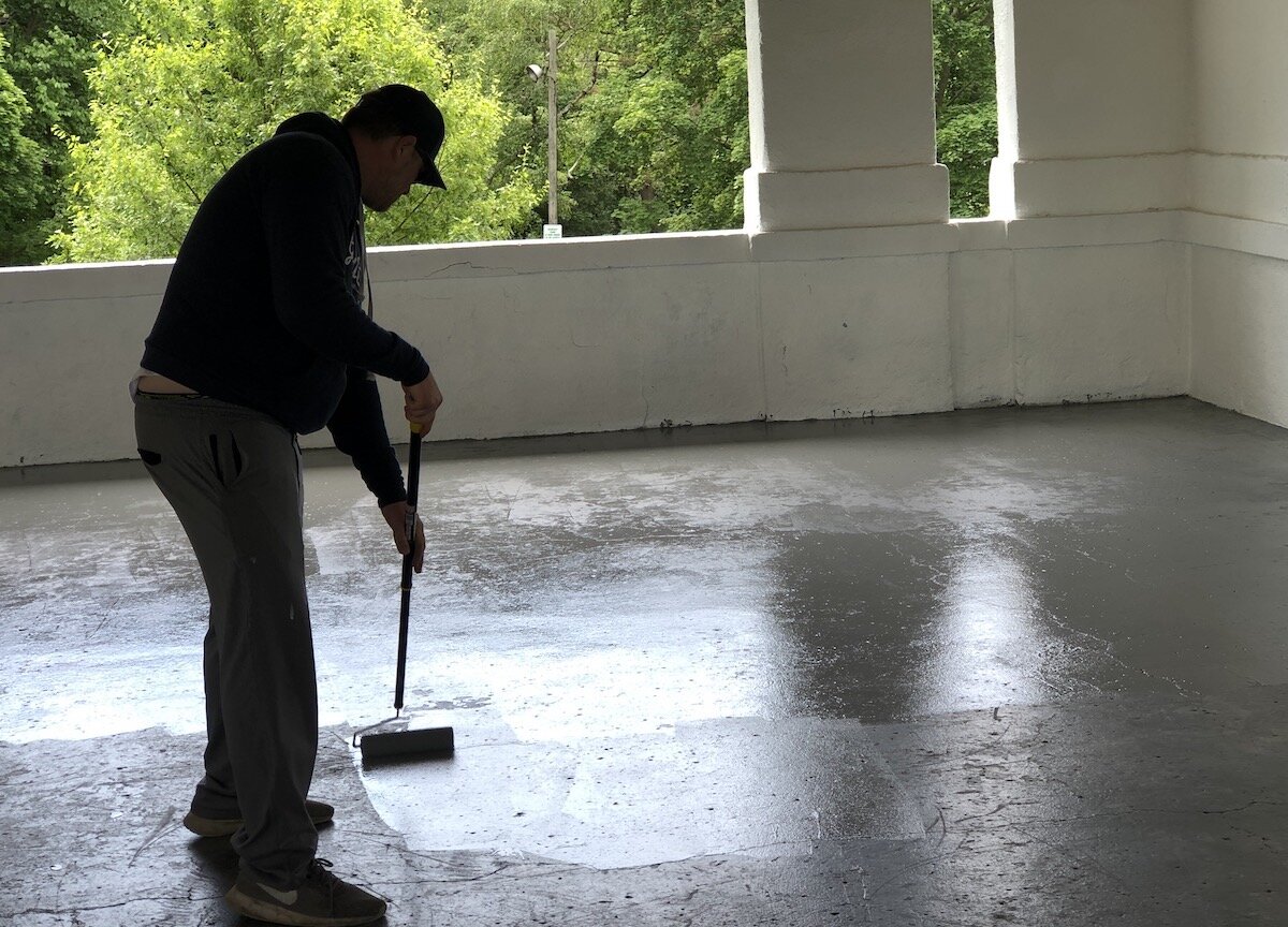 Steven Barber, a ninth ward write-in candidate, was among five candidates who helped paint the pavilion floor at Kearsley Park.