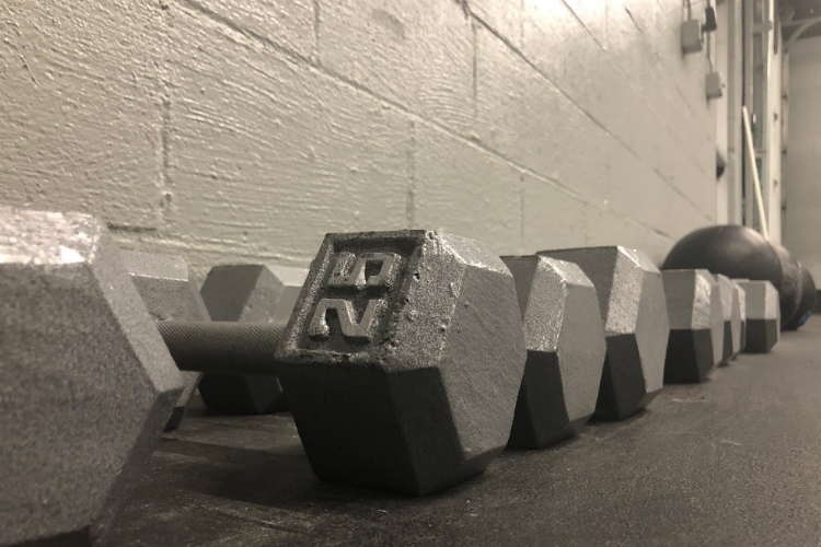 Weights line the walls ready for use at Flint CrossFit. 