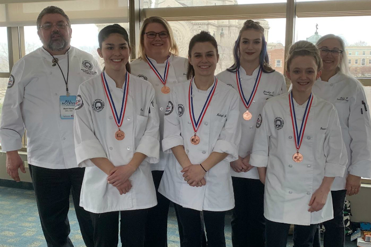 Mott Community College's 2019 Culinary Knowledge Bowl team (left to right): Chef Mark Handy, Martina LaNoue, Jennifer Stock, Kinleigh Jaehnig, Jessalyn Taylor, Dawn Neusbaum, and Lata VonBrockdorff.