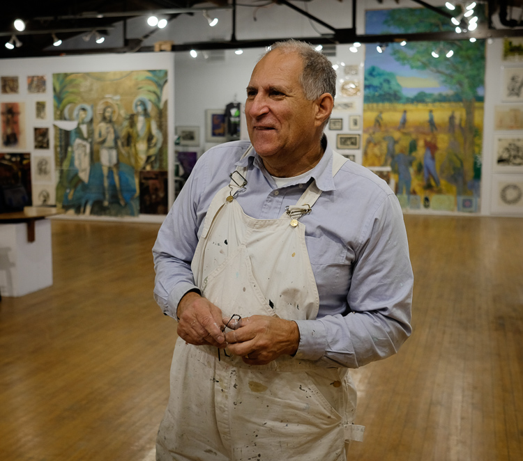 Mark Davidek, son of artist Stefan Davidek gives a tour of his father's work at the exhibit at Buckham Gallery in Flint.