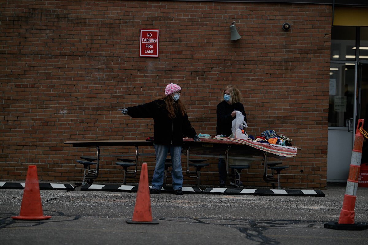 Debbie Summers (right) and another volunteer prepare for families arriving to receive donated Christmas gifts.