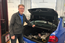 Keith Confer, engineering manager of Advanced Vehicle Systems for Delphi, stands next to an Intelligent Drive  system prototype at Kettering University's GM Mobility Research Center. 
