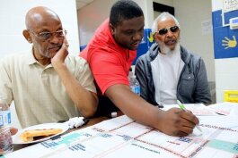 City of Flint Neighborhood Planner Dequan Allen leads a focus group beside Civic Park residents Ernest-C Martin, 72 (left) and Arthur Port, 77, (right) on September 7 for the neighborhood planning workshop.