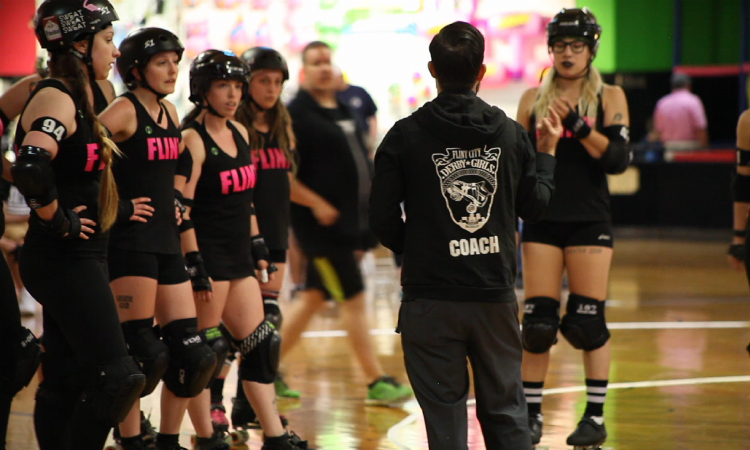 Flint City Derby Girls head coach Nicholas Cotton gives out pre-game instructions to his starters. They beat the Kalkaska Small Town Outlaws 259-101 to maintain their undefeated season.