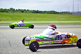 Young participants racing to the finish line at the 2nd annual Flint Soap Box Derby Race that took place in June 2022.