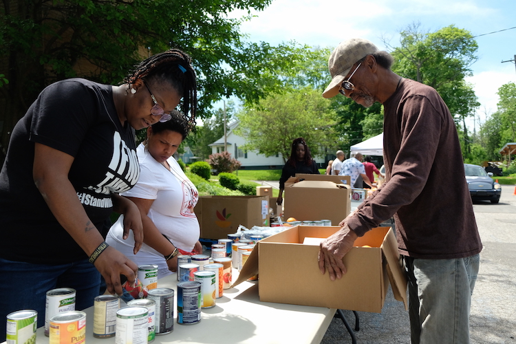 Prior to the V2xV grand opening, volunteers distributed food to neighborhood residents.