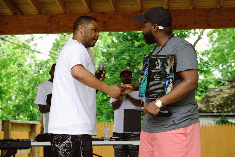 After his showcase performace, Jon Connor, Flint native rapper and producer, was presented with a V2xV studio recognition plaque for his musical contributions on behalf of the Flint community.