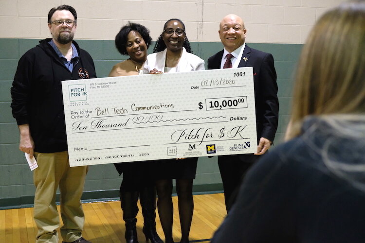 Linda Bell poses with her $10,000 check for her application Bell Tech Communications, a communication app for deaf and hearing people.