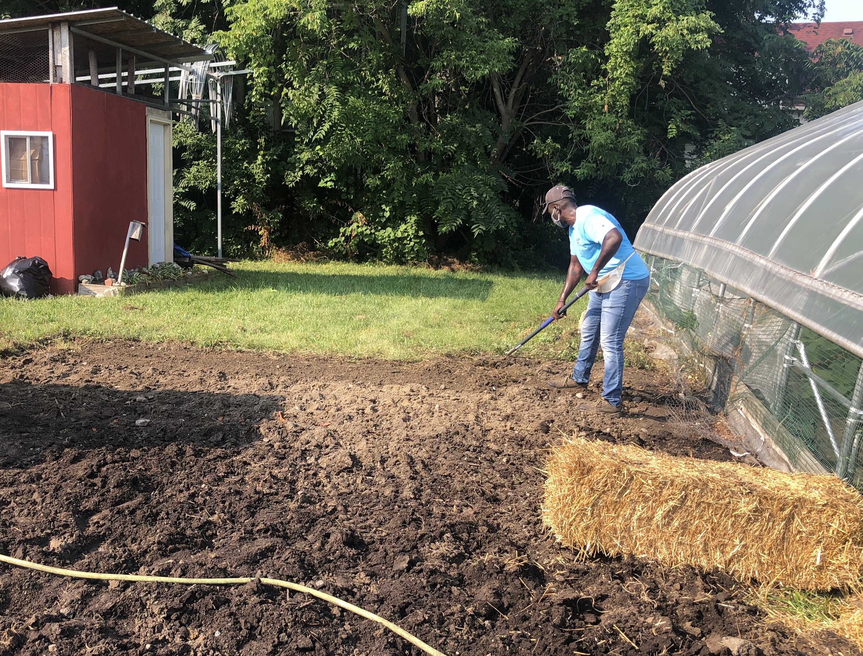 Ge'Von Collins works on the Edible Flint Educational Farm.