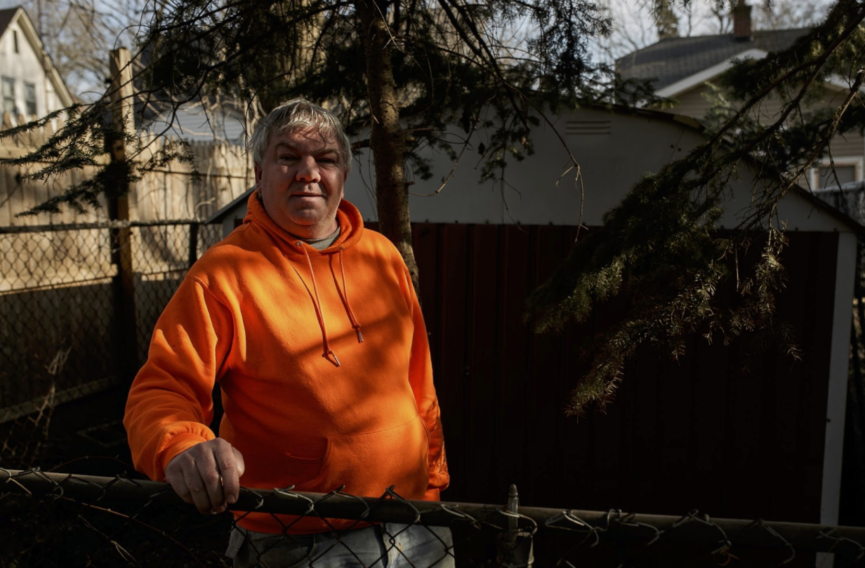 Kenneth D. Elder,  a resident of Eastside Franklin Park, stands in his backyard overlooking a yard behind his home that was cleaned up on May 15.