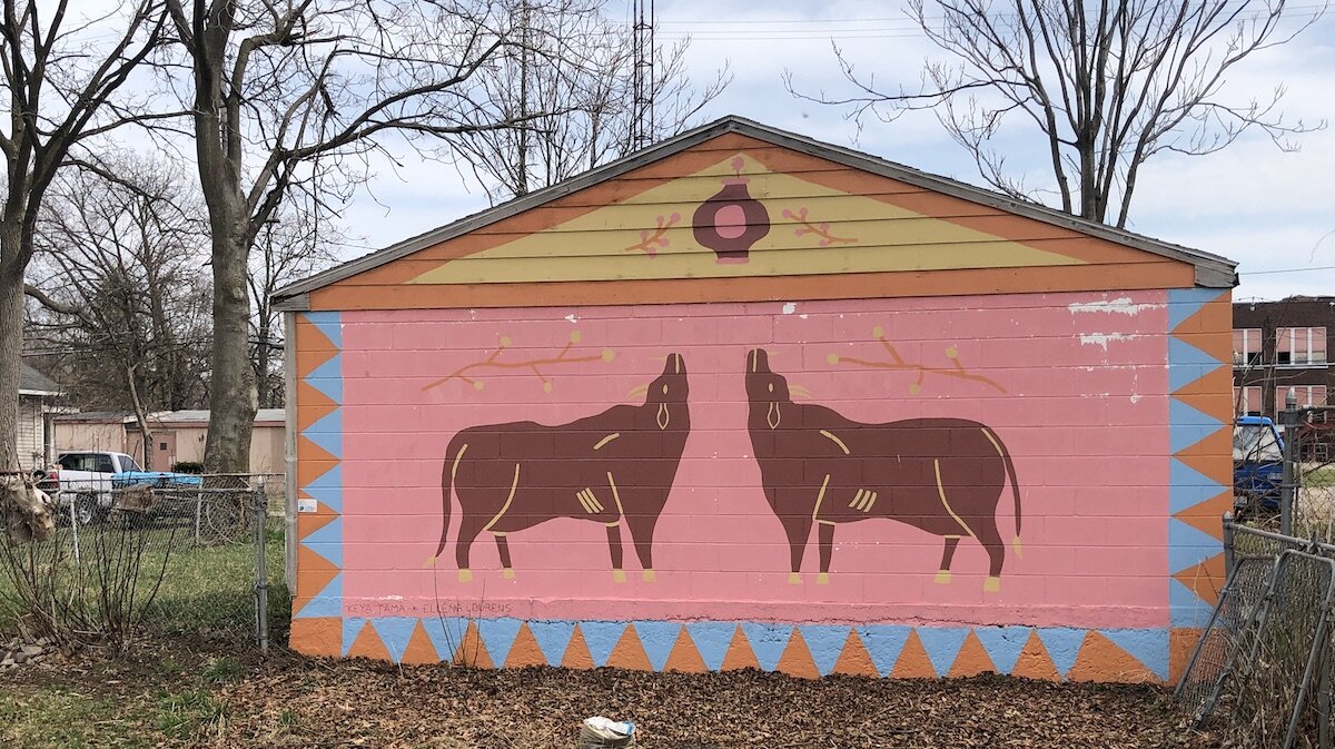 A Flint Public Art Project mural overlooks a community garden in the Eastside Franklin Park neighborhood.