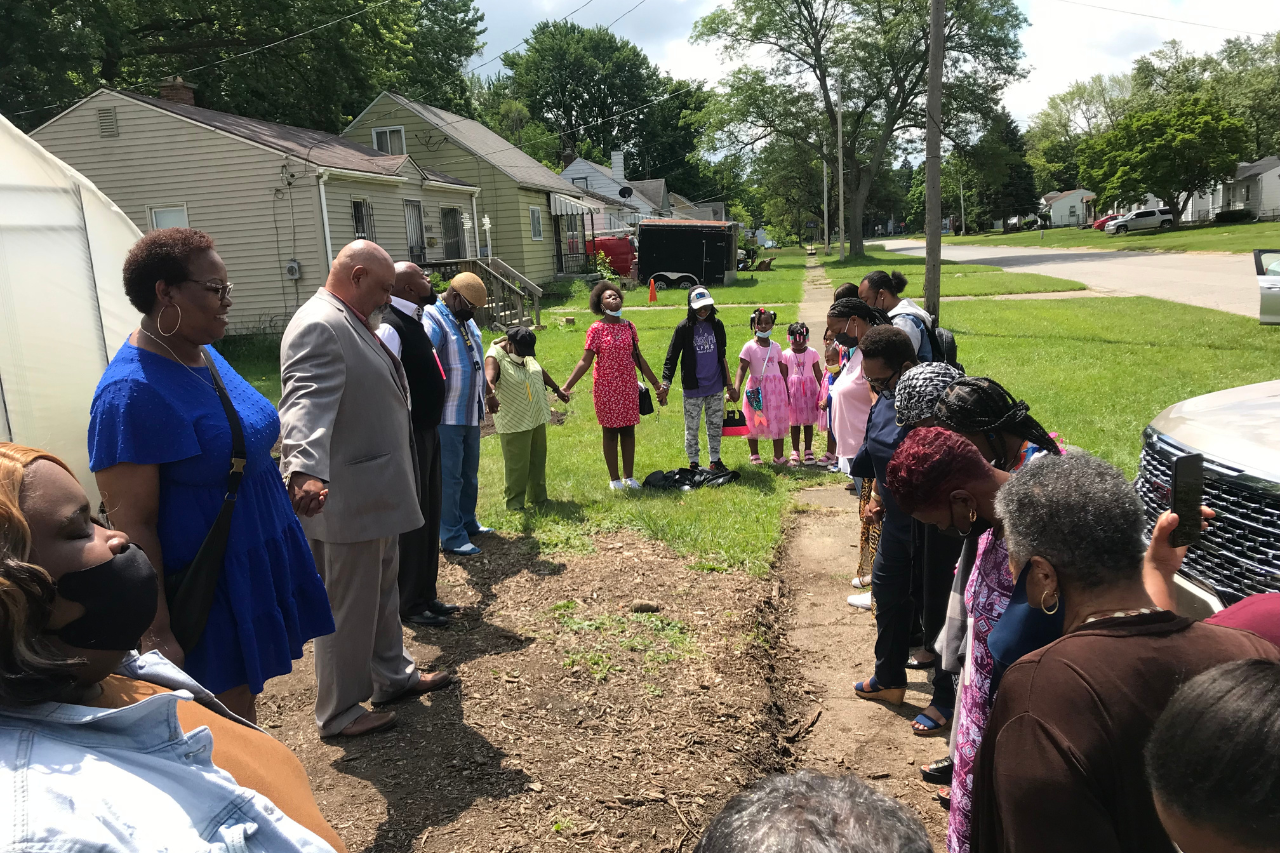 Residents outside of EJ's Garden giving thanks and prayer.