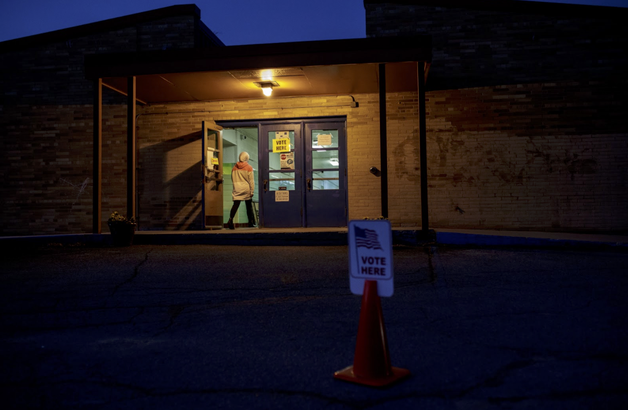 Mariam Tabbah, 19, poll volunteer and election vice chairperson, walks into Pierce Elementary where residents for precinct 46 voted.