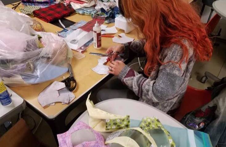 Naomi Villaranda working on masks with windows for the Deaf and Hard of Hearing at Factory Two.