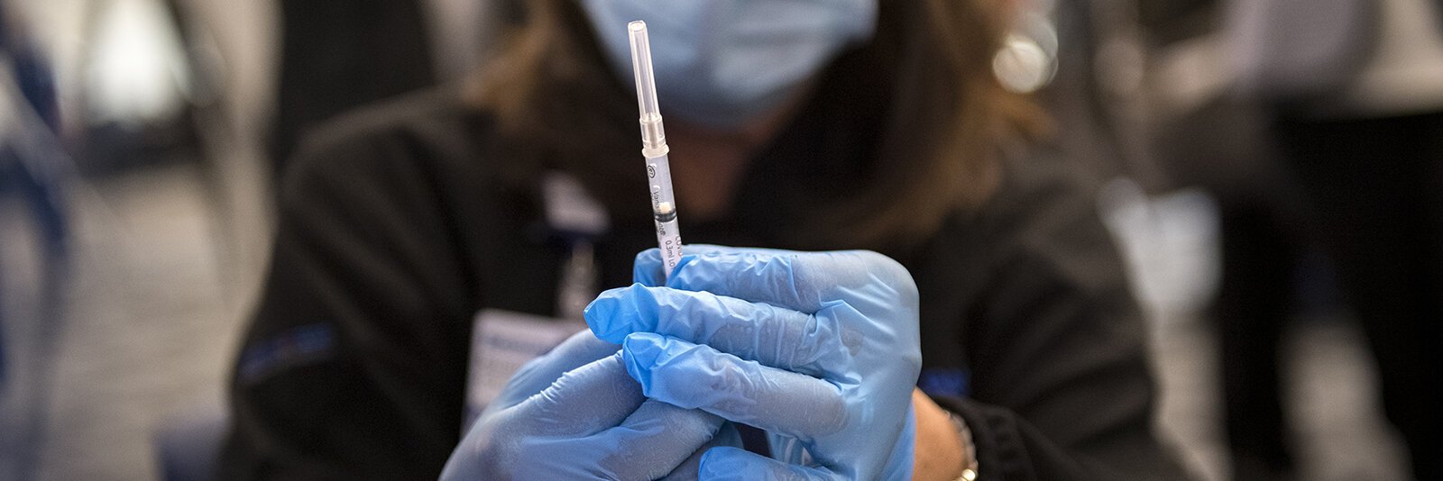 Susan Grant handles the first dose of the COVID-19 vaccine at Beaumont Service Center in Southfield on Dec. 15, 2020. 