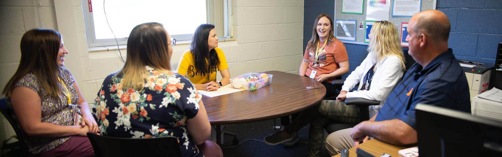Airport Community Schools staff including Supt. John Krimmel (far right) confer with Family Medical Center staff including School Based Services Supervisor Meredith Gilliam (far left) and Behavioral Health Therapist Alexis Cavins (in orange shirt). 
