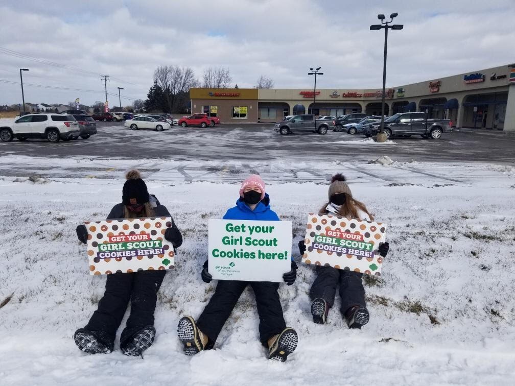 Local Girl Scouts advertise their Cookie Booth.