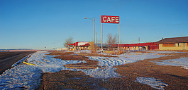 Rod Penner, American, b. Canada, 1965. Sands Motel & Café, 2019. Acrylic on canvas, 31 x 64 in. Collection of Louis K. and Susan P. Meisel.