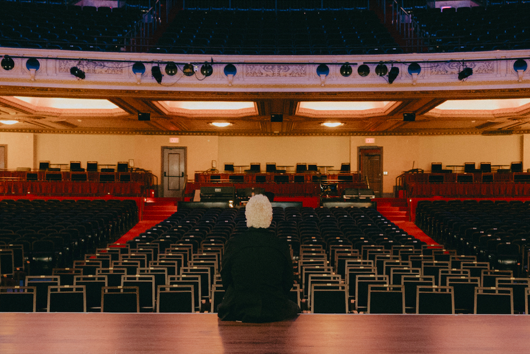 FIM's President and CEO, Rodney Lontine, sits pensively onstage inside the Capitol Theatre in downtown Flint on June 18, 2025. 