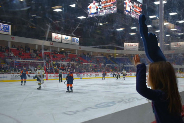 Kid Two, Firebirds claw in hand, cheers on the team