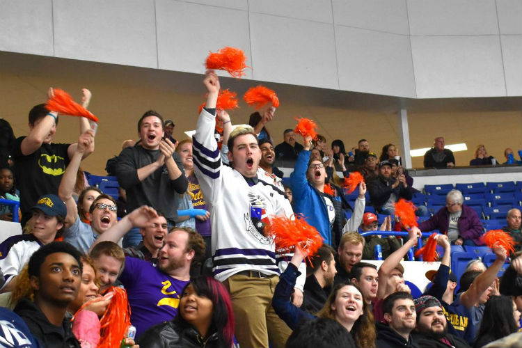 A group  of Kettering University students root for the home team.