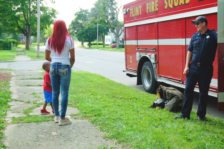 Between the food and games, the Flint Fire Squad lined up curbside at the Civic Park Centennial Pavilion offering fire truck tours for kids.