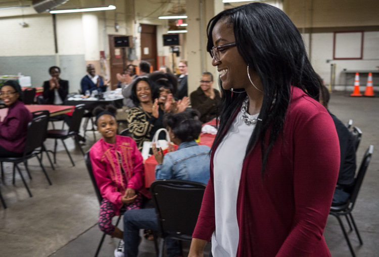 Porcha Clemons walks toward the podium to receive her winning microgrant at the Flint SOUP event in October 2017 at Factory Two in Flint. She won more than $1,300 for her dance studio.