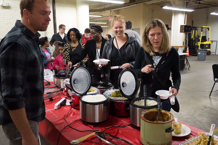 Those in attendance file through the food tables at Flint SOUP during the October event at Factory Two in Flint. For a $5 donation, those attending receive soup, salad, bread, and a chance to vote in the evening's microgrant competition.