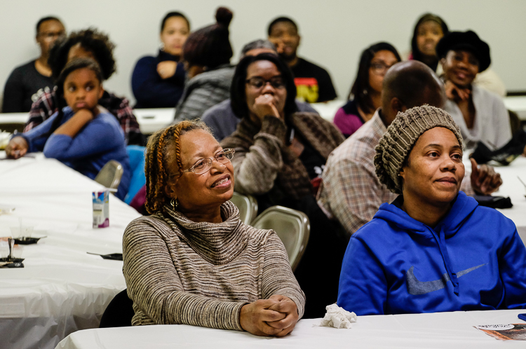 Gloria Brown of Burton (left) and daughter Mikasa Brown of Flint listen to presentations at the Flint SOUP event last week in January 2018 at the Church of the Harvest International  in Flint.