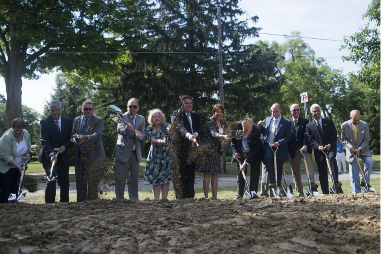 Community members shovel dirt during a groundbreaking ceremony at the Flint Cultural Center Academy Tuesday, June 26th, 2018 in downtown Flint. The new public, nonprofit charter school will serve students in grades K-8. 