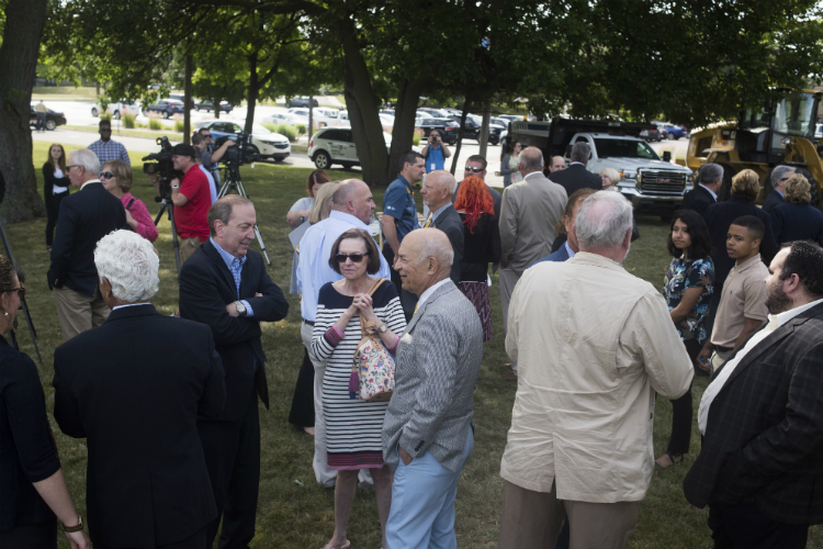 Onlookers gather on the Flint Cultural Center Campus awaiting the groundbreaking ceremony for a new 650-student charter school being built there. 