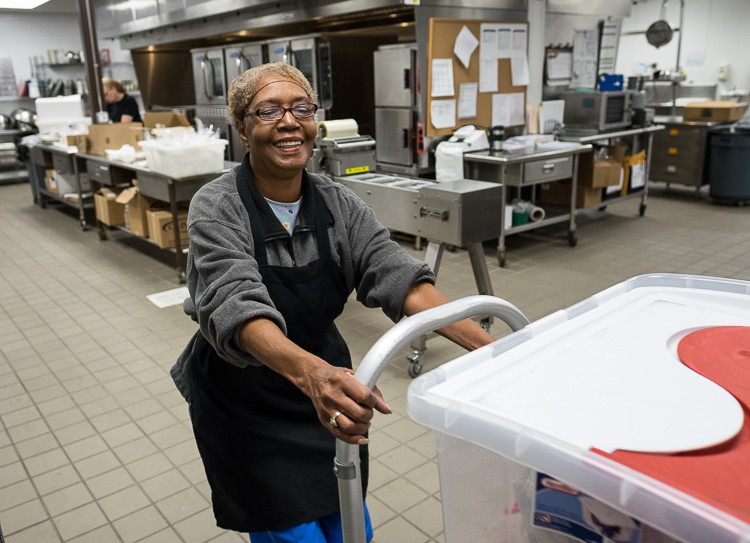 Petenia Atkins, a food service associate, stages crates of meals to be loaded onto trucks in the production kitchen at the Food Bank of Eastern Michigan in Flint.