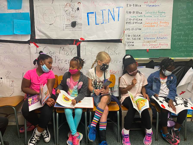 Four CDF Freedom School Summer Program K-2nd grade scholars read during class time.