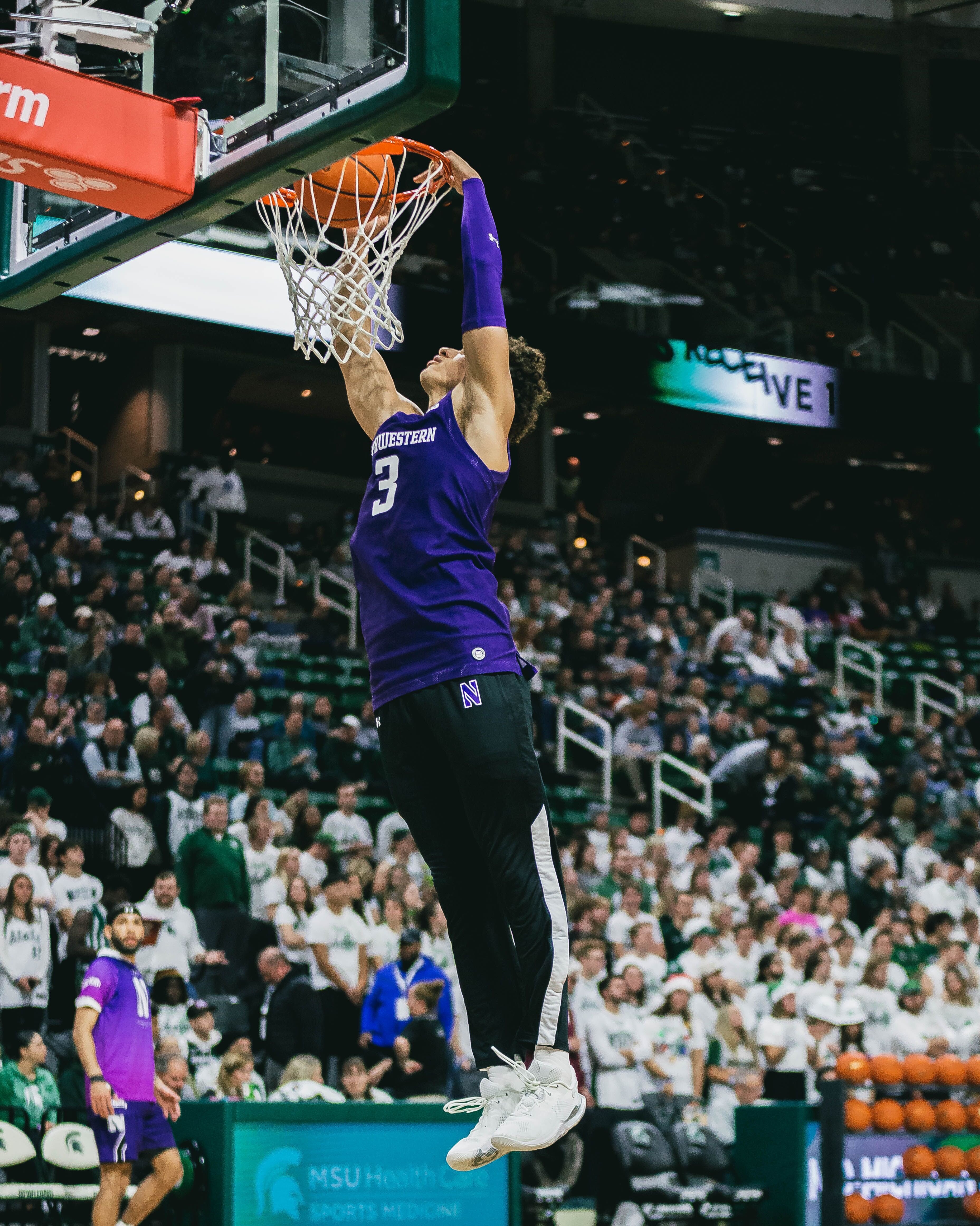 Northwestern's Ty Berry floats while delivering a dunk during Sunday's game.