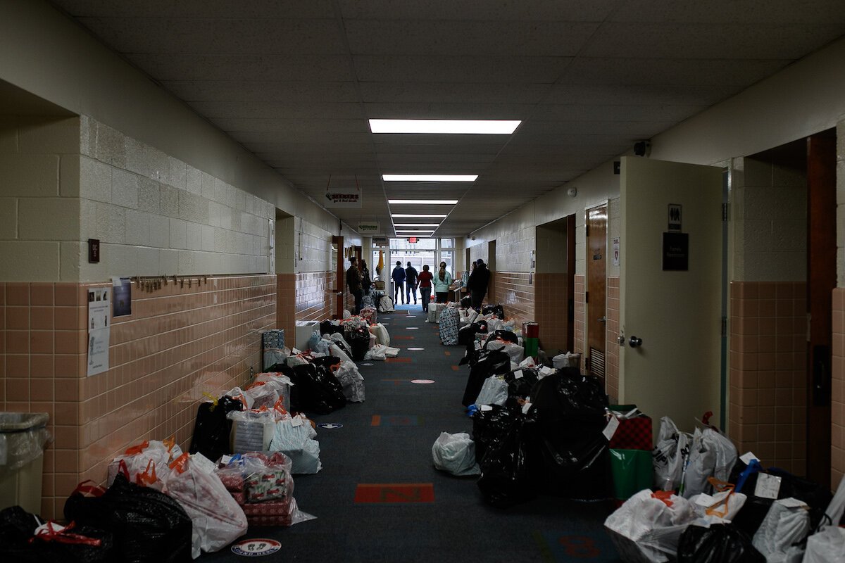 Gifts donated by local parishioners line the hallways of Holy Redeemer's outreach facility as volunteers prepare to hand them out.