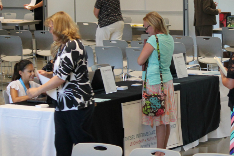 Alexandra Sexton (sitting) volunteers during the 2017 job fair at GISD.