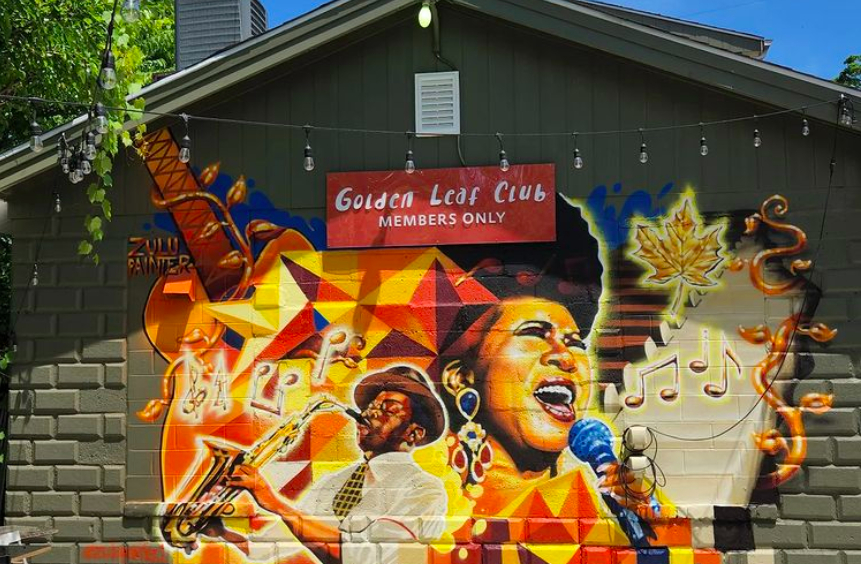The new mural at The Golden Leaf captures elements of music notes, golden leaves, and the legendary Aretha Franklin mid-song. 