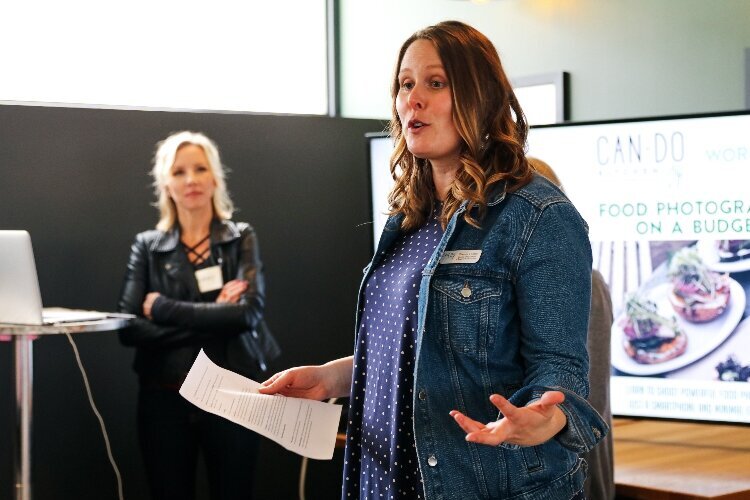 Sheena Foster, of Can-Do Kalamazoo, speaks as Lindsay Broveleit, from Newhall Klein (now Matato), looks on.