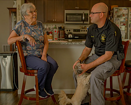Genesee County Sheriff's Deputy Christian Bowman, of the GRACE Team, visits Pat Kain, a Grand Blanc resident that he helped after she'd been receiving phone calls from an individual posing as a federal agent, at her home on Wednesday, Aug. 30, 2023.