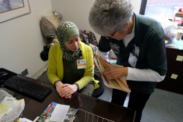 HELP program director Ruba Mahfouz Alkotob and volunteer Millie Hursin discuss patient needs at Hurley Medical Center.