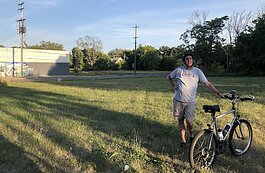 Dr. Thomas Henthorn, shown here giving a bike tour of Flint's neighborhood history, was a recipient of a Michigan Humanities award.